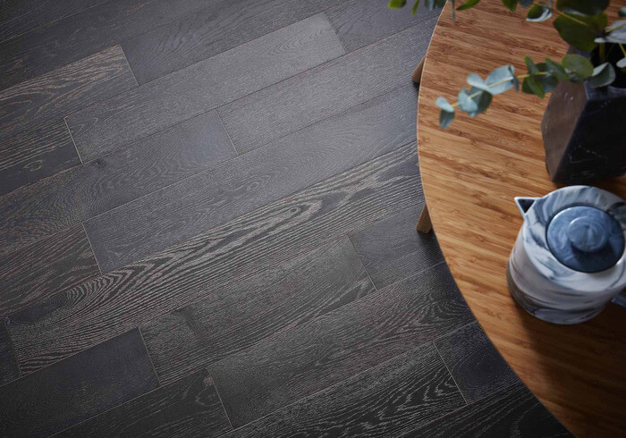 A top-down view of a coffee table and dark wooden flooring