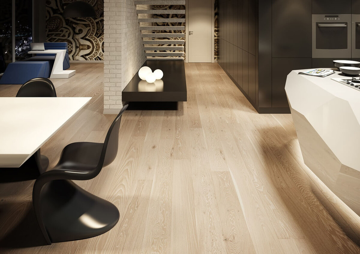 A modern living room with wooden floors, an open staircase and exposed brickwork