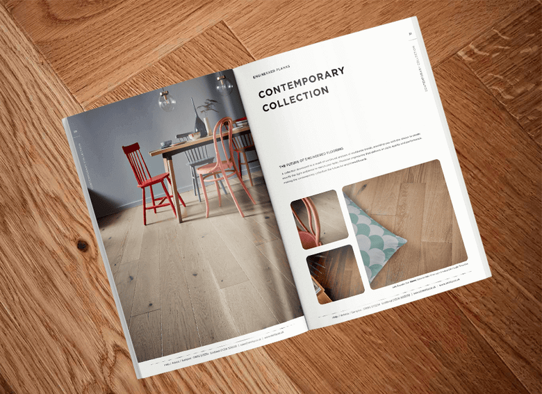 An open brochure on a wooden floor.