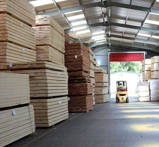 Prepared wood stacked in a warehouse.