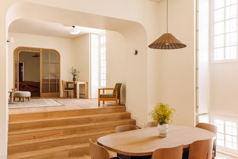 A styled chair and table on a wooden floor.